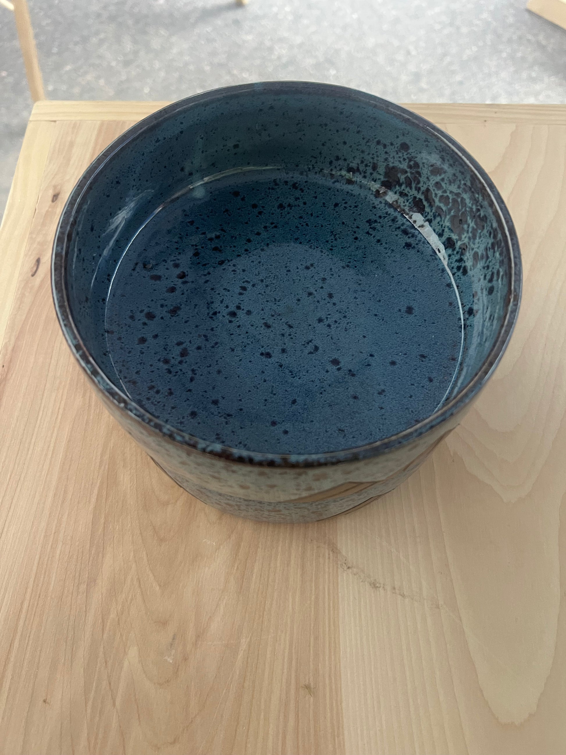 a blue bowl with a blue liquid in it