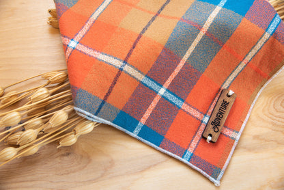 a close up of an orange umbrella on a wooden floor 